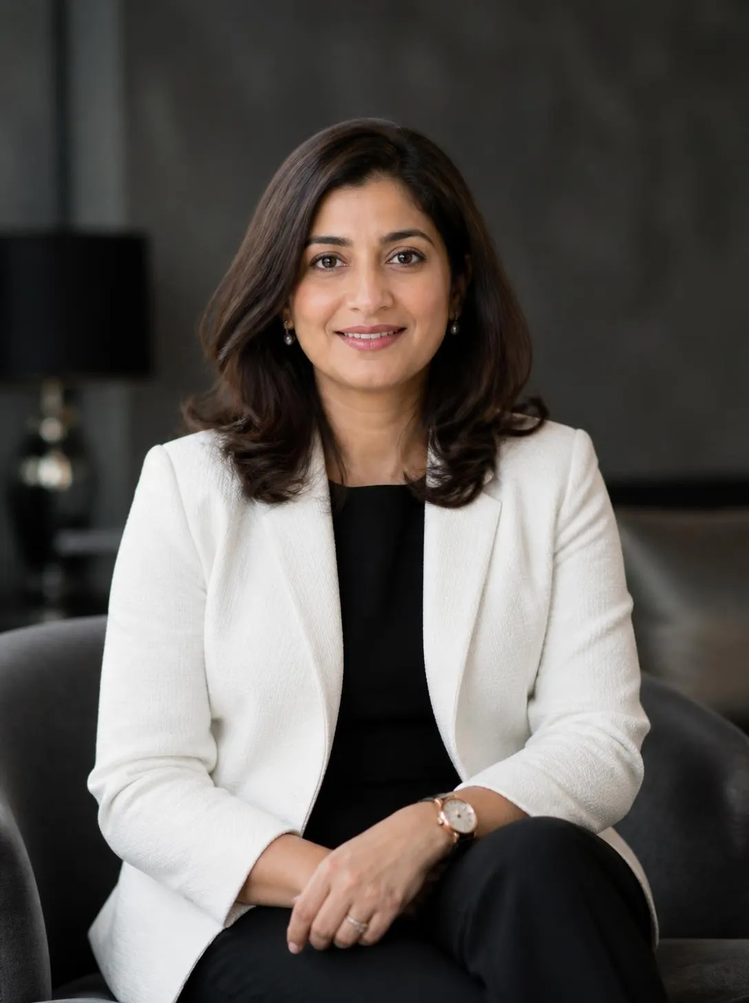 A confident woman entrepreneur smiling in a warm workshop