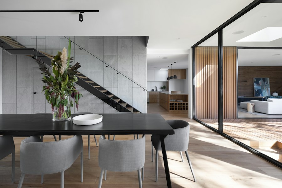 Contemporary interior living and dining space with bespoke woodwork and lighting