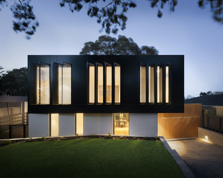 Vikram Das’s commercial project: a dark-clad building lit warmly at dusk