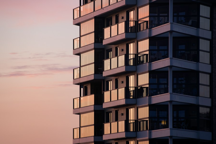 Maplewood Apartments — a renovated residential tower with glass balconies at dusk