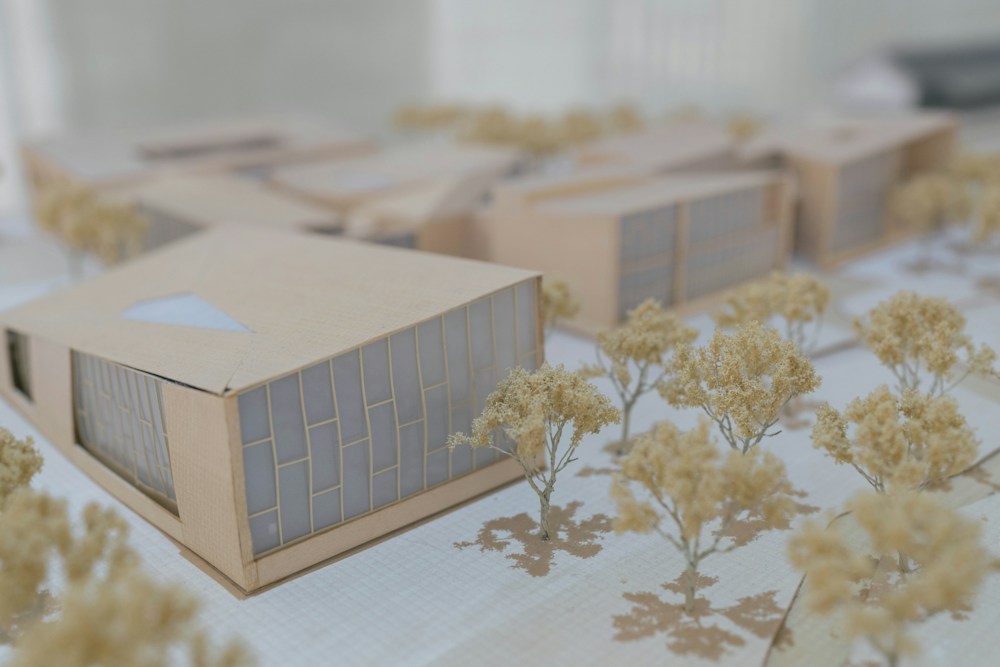Architectural scale model of a modern building surrounded by miniature trees