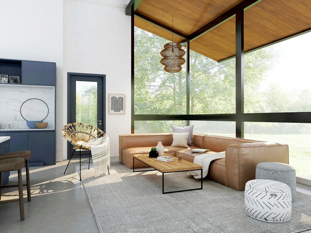 Renovated open-plan living room with a leather sofa, timber ceiling and floor-to-ceiling windows
