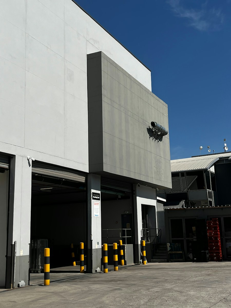 Riverton Industrial Hub — a modern industrial facility with loading docks and clean facade lines